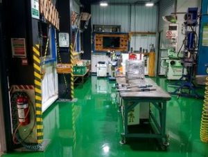 High gloss green industrial epoxy flooring by Chemflex Chemicals at a large stationery factory in Colombo, Sri Lanka.